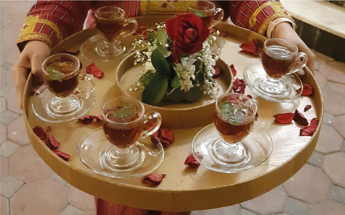 a group of glasses of tea on a table / Arabic coffee service shop
